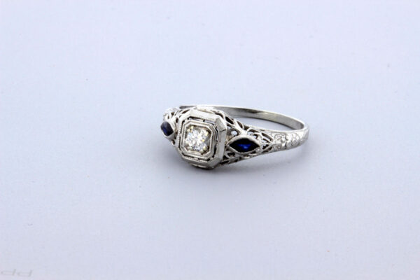 Timekeepersclayton 1920s 18K White Gold .11ct Diamond ring with Blue French Cut Accents with Flowers and Filigree